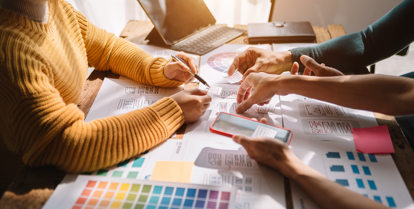 UX graphic designer planning application process development prototype wireframe for web smart phone. Creative digital development agency.