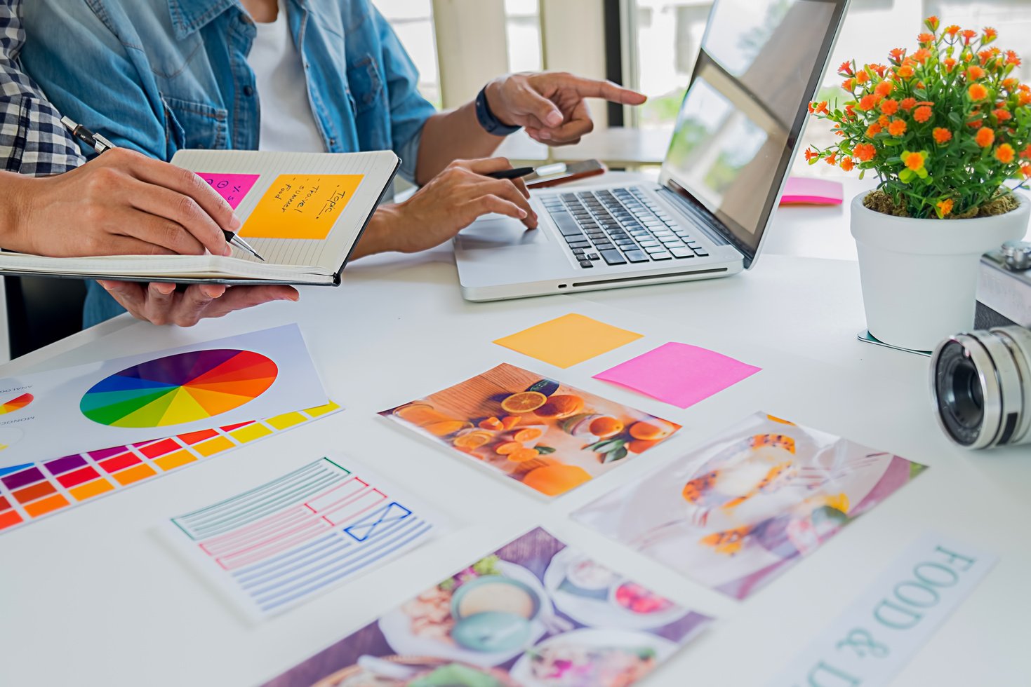 Asian advertising designer creative start-up team discussing ideas in office.